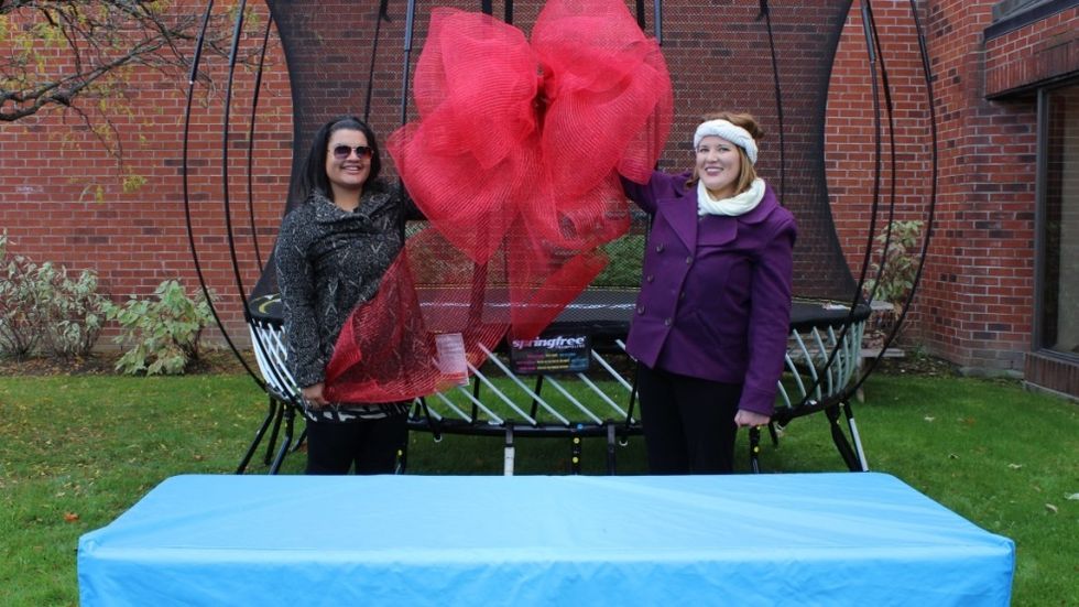 Have one person hold the bow in place in between two enclosure rods.   Using wire, affix the bow on either side to the enclosure rods.