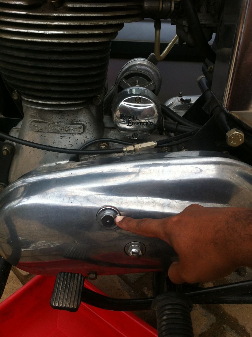 Have the vehicle on center stand on a horizontal surface and then open the inspection hole.