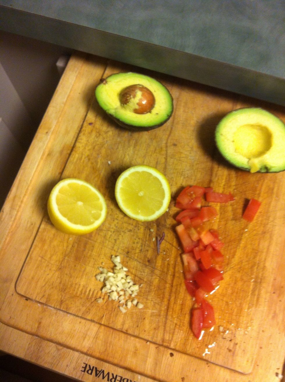 Have this ready, were going to use half the lemon for the sauce , the garlic for the beans, the avocado for a guacamole type thing and the tomatoes as a finishing garnish \ud83d\udc81