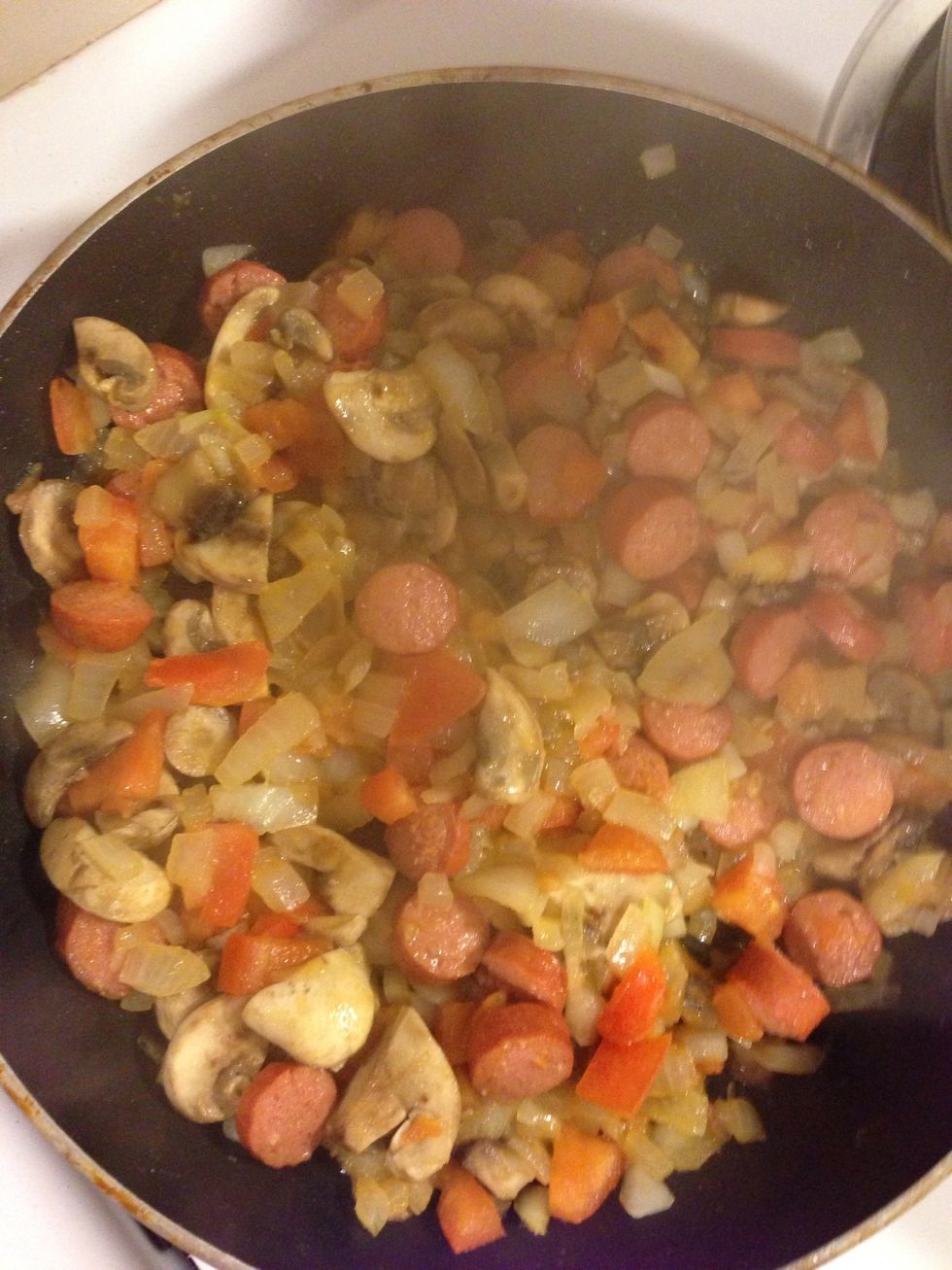 He sipped the water again and said "I think it's missing something, I guess some vegetables." again the old woman ran and brought  an onion, tomato, mushroom, hotdogs and olive oil in a pan.