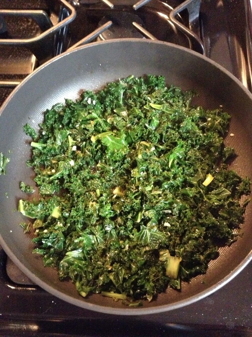 Heat 2 tbspn's olive oil and add kale. Cook until wilted and deep green color. Add about 1 tspn crushed garlic, 1/2 tspn salt, black pepper (to taste), splash of lemon juice and chicken broth. Simmer.