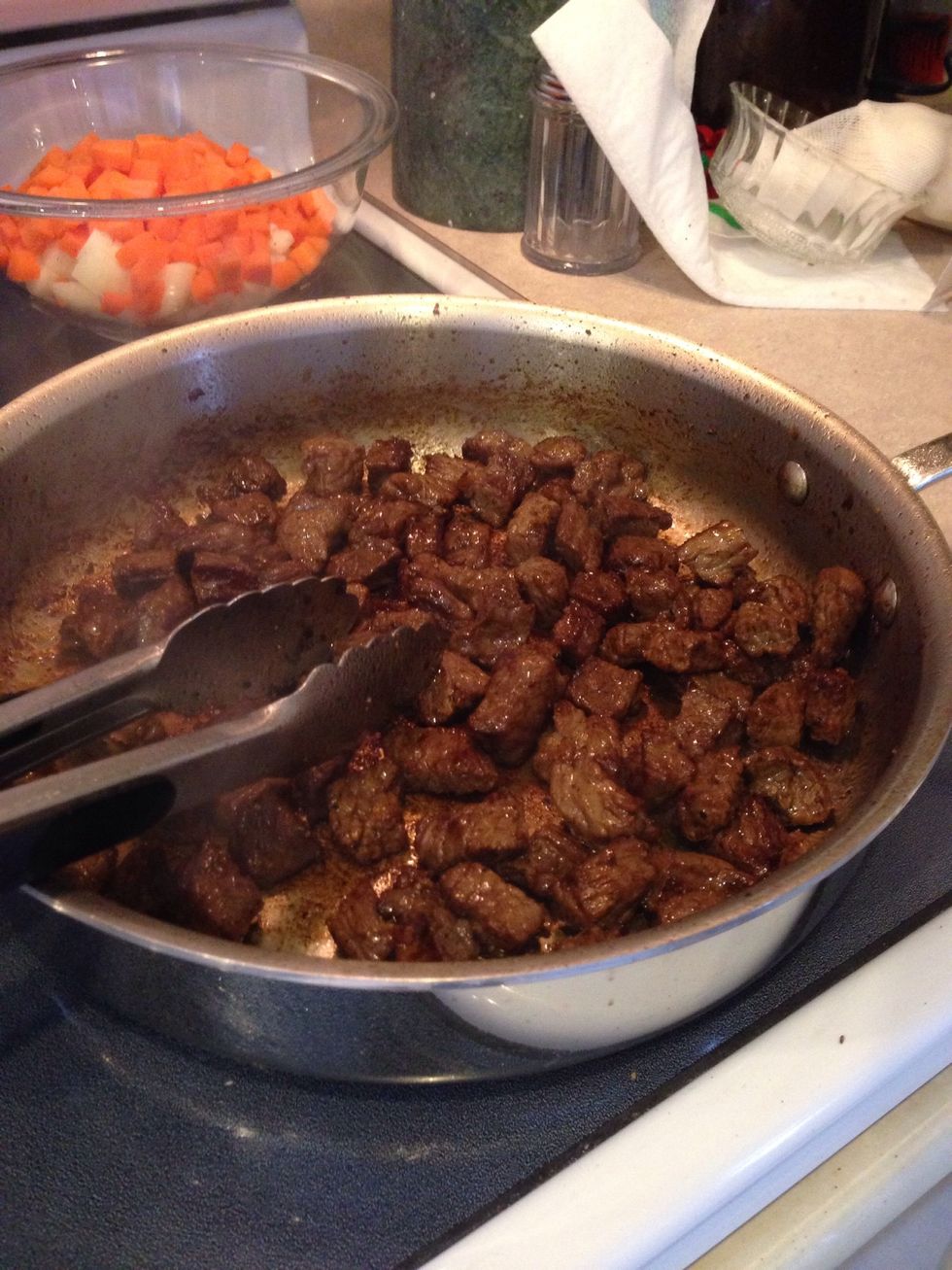 Heat 2 teaspoons of the oil in a 12 inch skillet over medium high heat and brown half of the beef, about 10 minutes, then add to the slow cooker. Repeat with 2tsp oil and the rest of the beef.