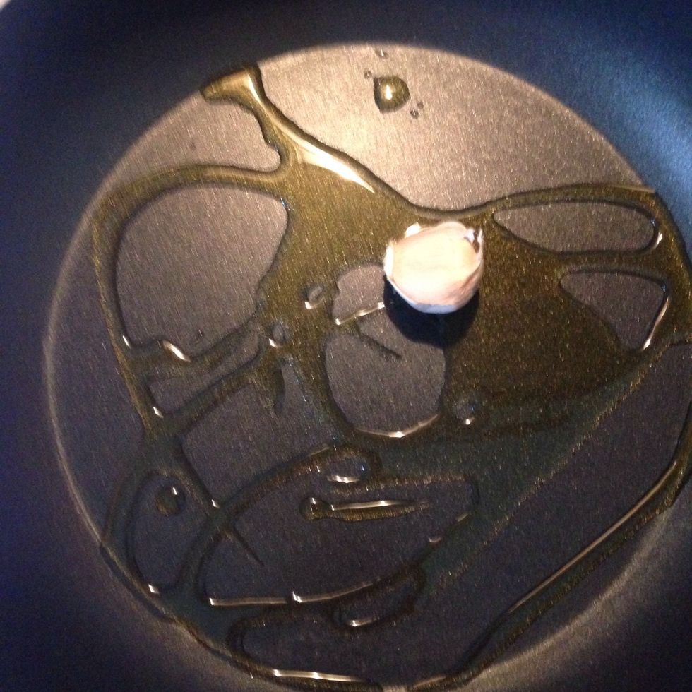 Heat 3 spoons of olive oil and a garlic in a large pan