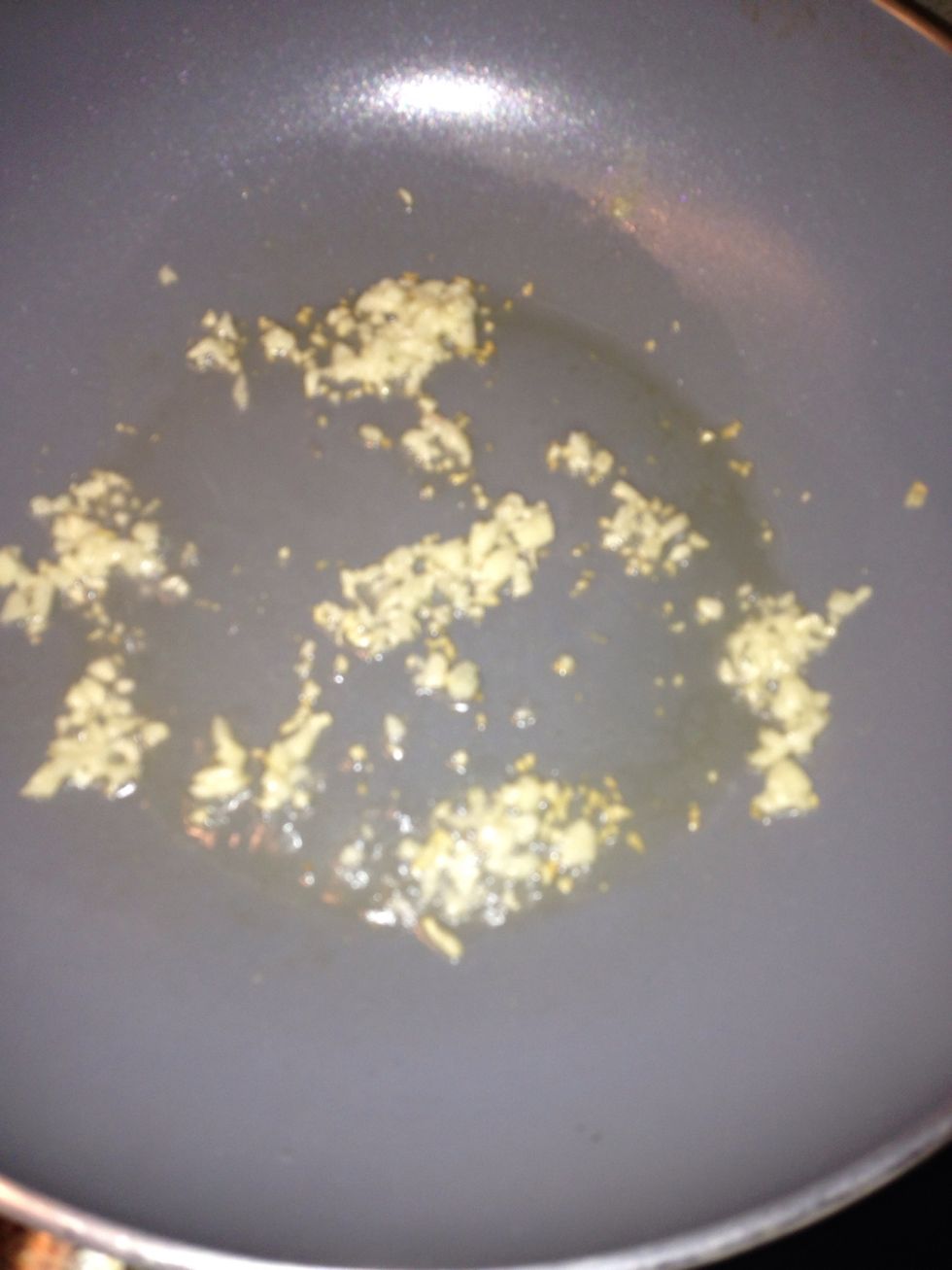 Heat 3 tablespoon of oil in the wok and add chopped garlic to the wok.