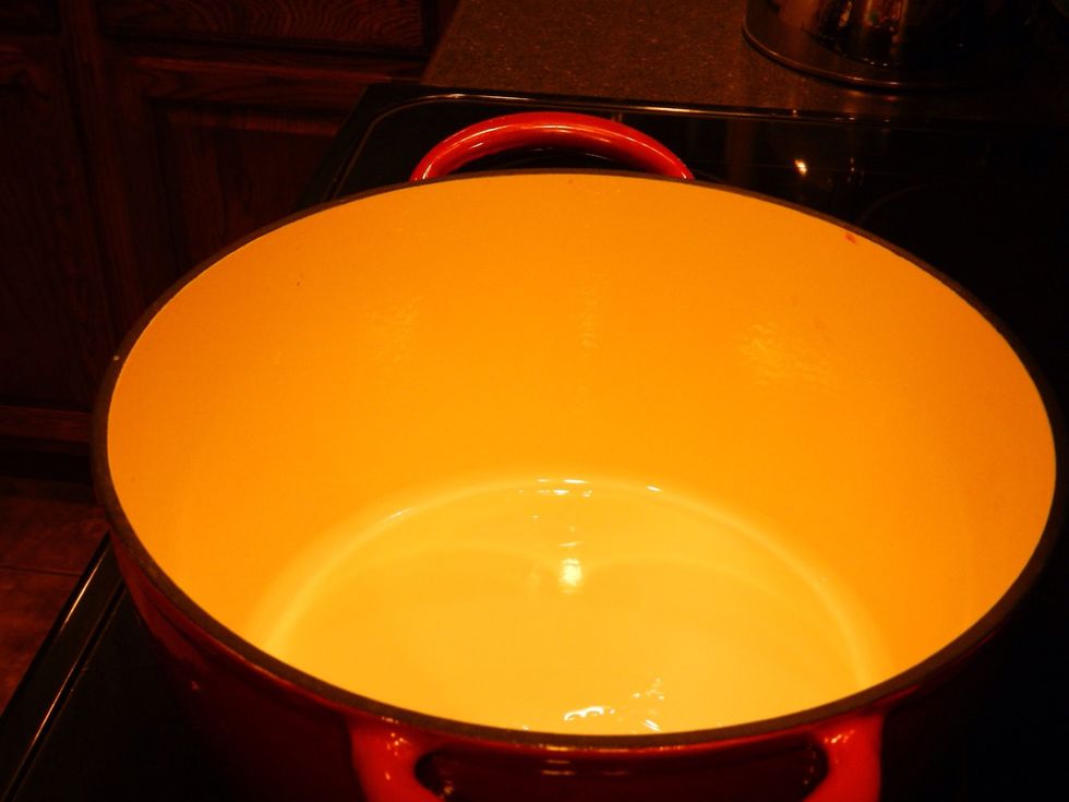 Heat 3T of any oil you'd like over med-high heat in a heavy pot.  Mine is a porcelain covered cast iron pot.