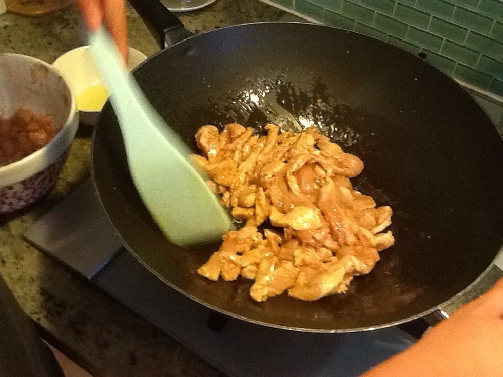 Heat 4 table spoons of oil into a large wok lover high heat then add chicken