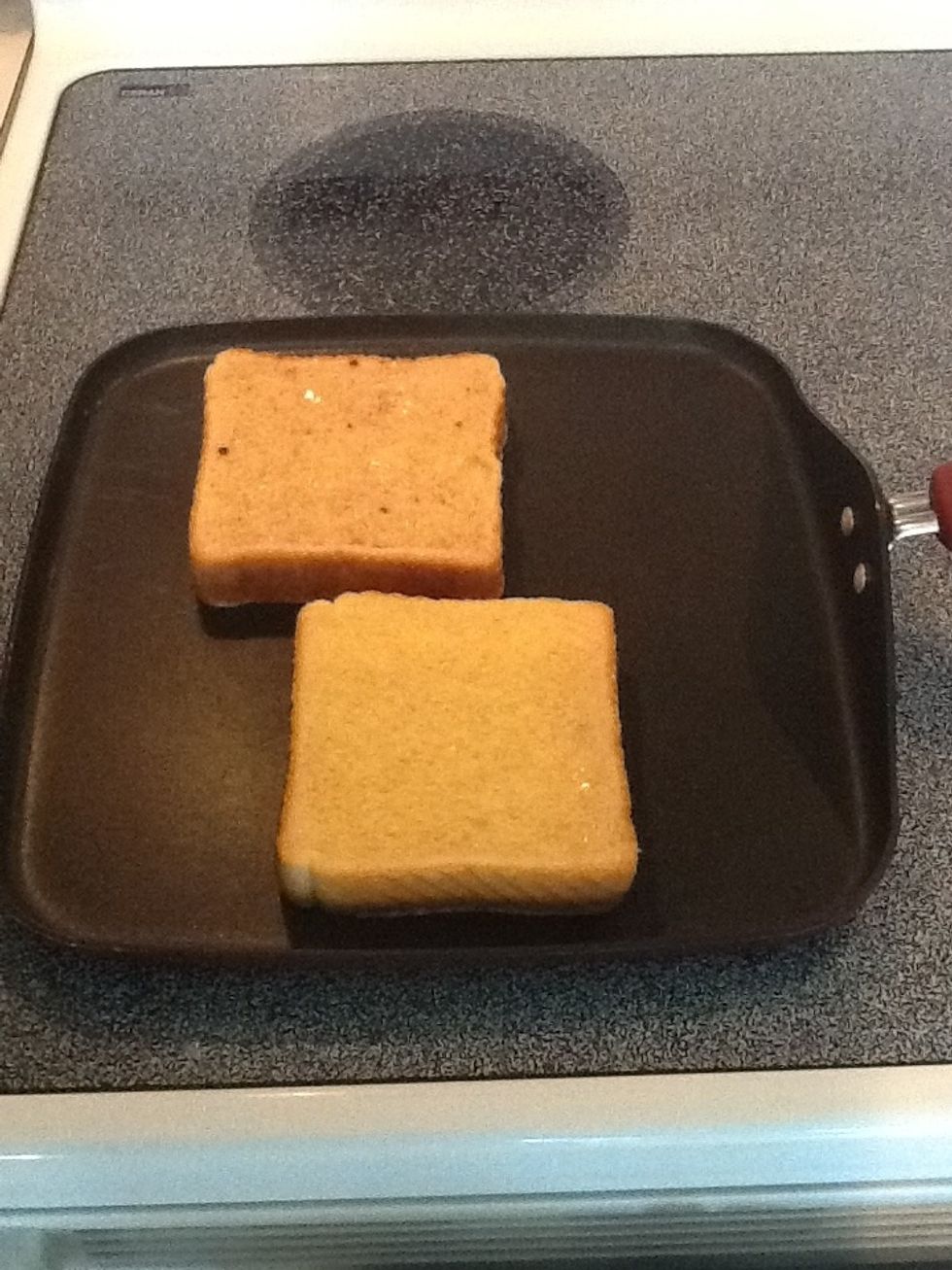 Heat a burner to medium heat and place the egg soaked bread on a preheated skillet.