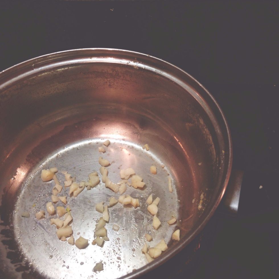 Heat a casserole with fry light and add garlic.