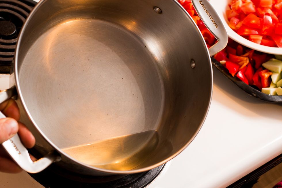 Heat a large enough pot with oil .