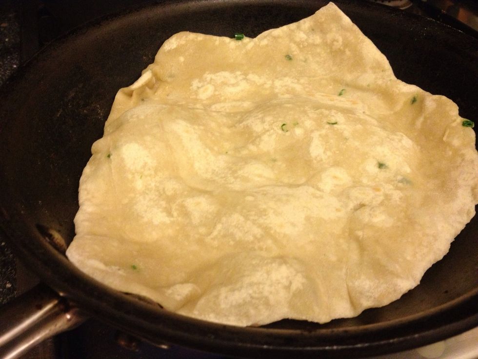 Heat a large frying pan on high! Place in chapatti and let cook until it goes slightly translucent and starts to bubble - flip and repeat! Once each side has slightly browned remove from pan!