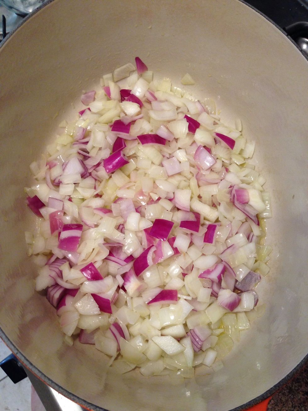 Heat a large heavy bottomed casserole over medium heat; add 3 tablespoons olive oil and the onions. Note: I had half a red onion, so I threw it in for color.