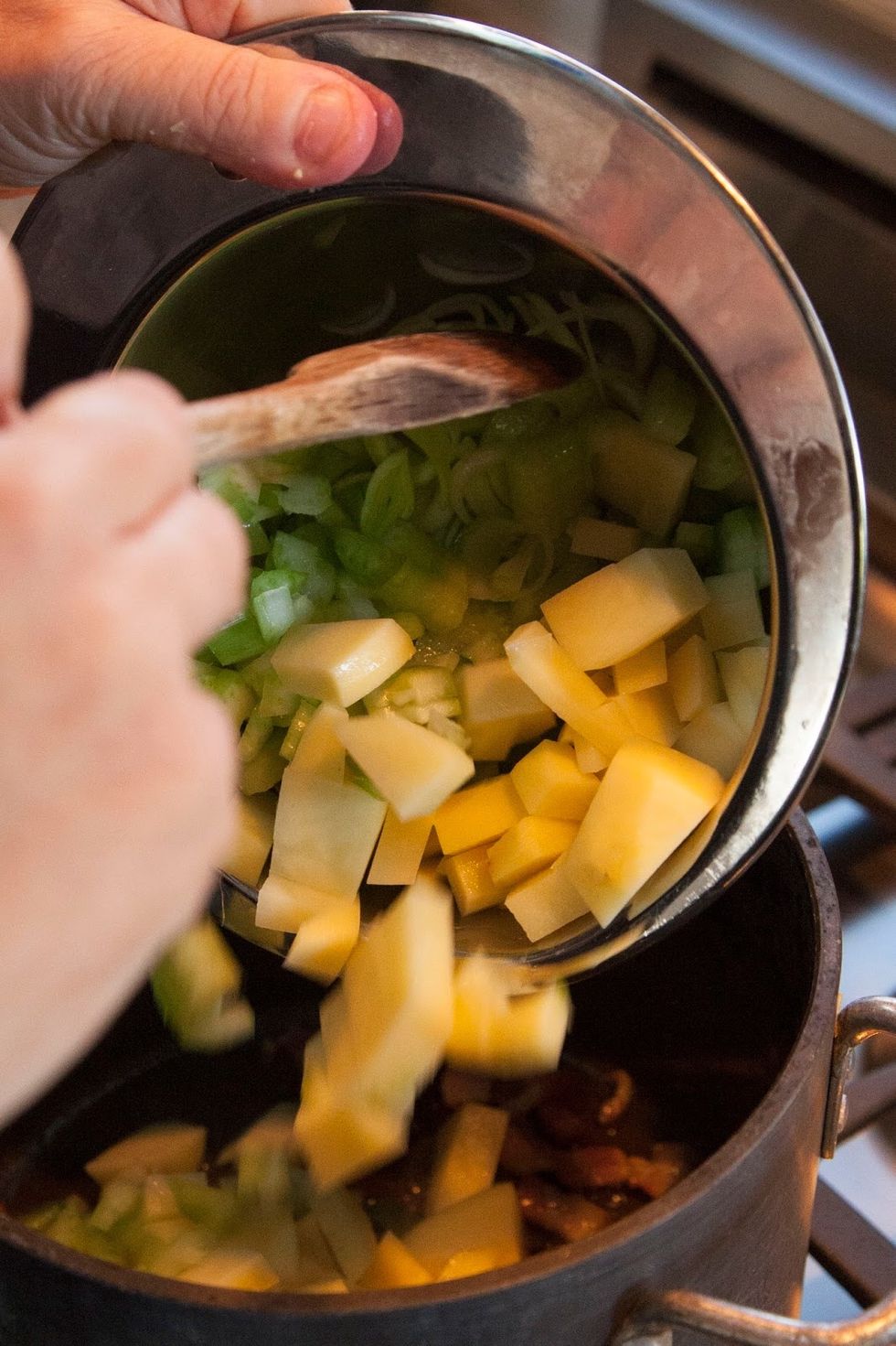 Heat a large soup pot on the stove and drop the bacon ( or olive oil or butter) in. Cook the bacon down until it starts to brown, then add in the chopped vegetables.