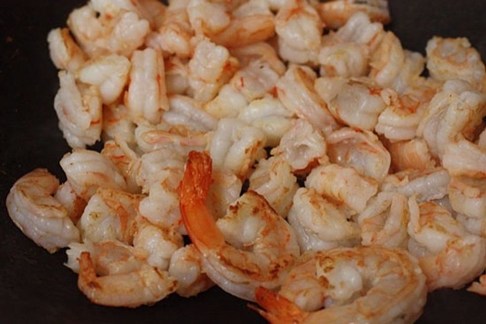 Heat a nonstick wok on high heat; when hot add oil. Add shrimp and cook a few minutes until almost cooked though. Set shrimp aside.