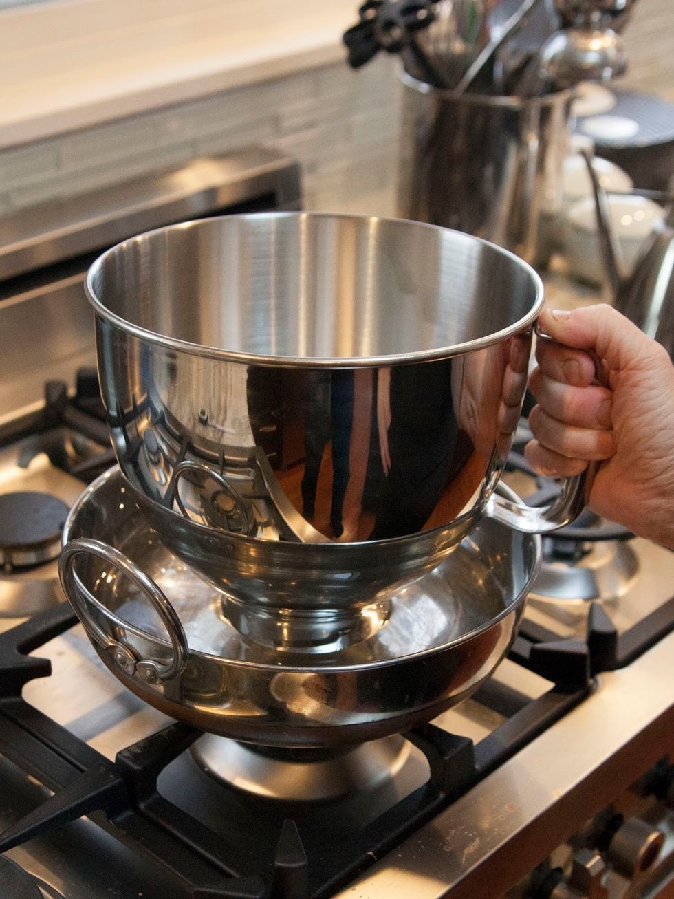 Heat a sauce pan filled with one inch water on the stove at medium heat. Place the bowl or the stand mixer bowl in the water.