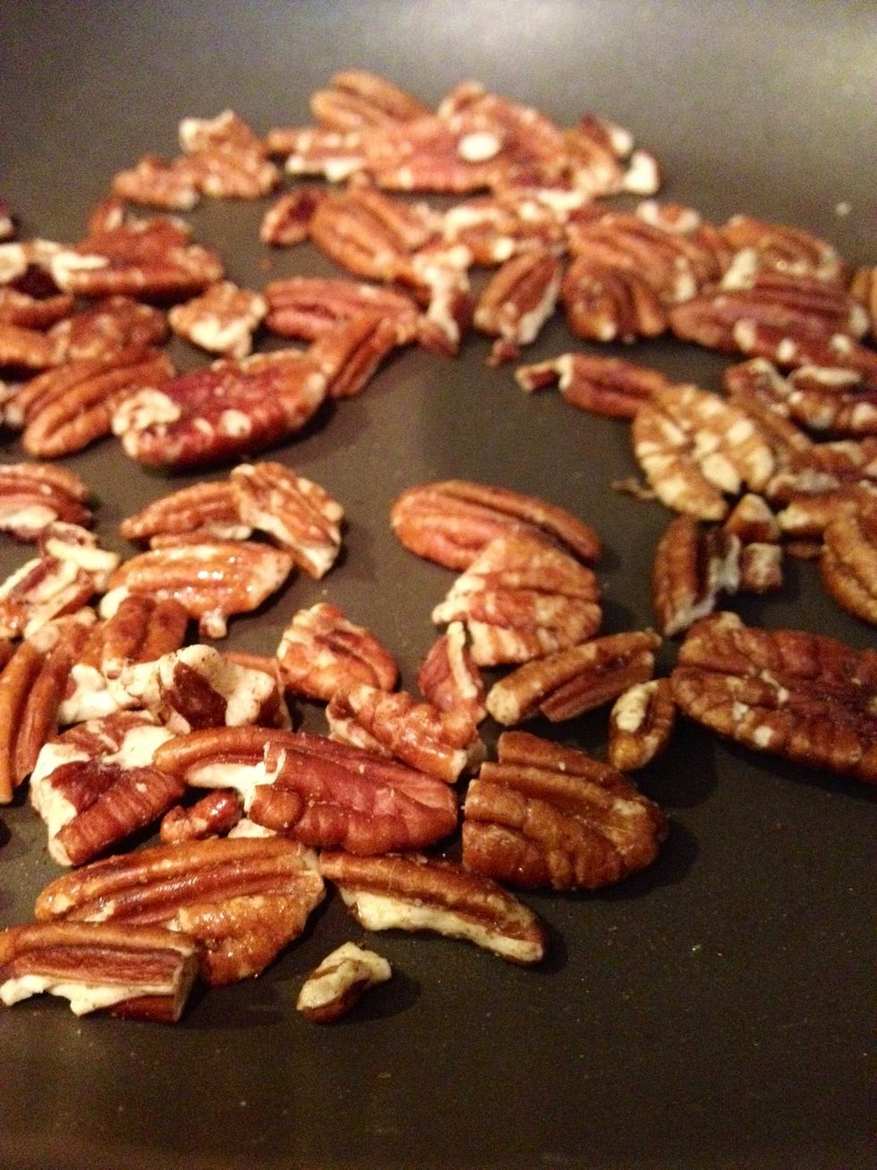 Heat a skillet on high. Reduce the temperature to medium and add the pecans. Stir continuously with a wooden spoon to avoid burning the nuts. They're done when they start browning and smell fragrant.