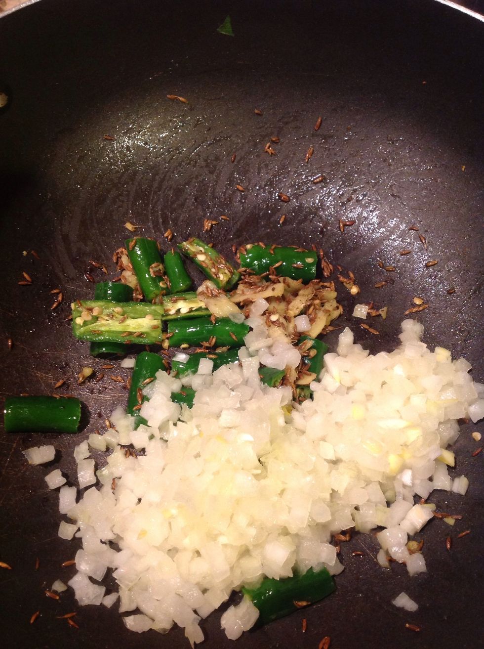 Heat a tsp of oil. Add 1 tsp cumin seeds, ginger, green chillies and the diced onions.