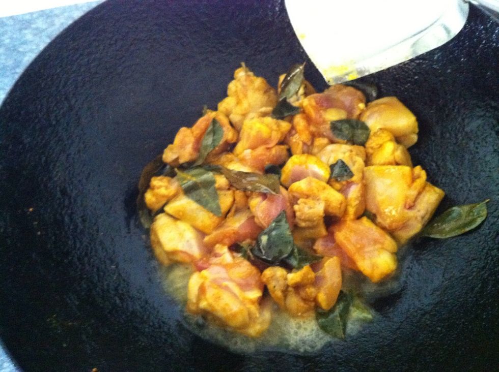Heat a wok. Add vegetable oil. Add the chicken mixture when the oil is hot. Stir well and ensure the chicken is cooked.