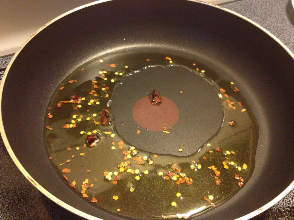 Heat about 3 Tbsp of veggie oil, and add in chili flakes. I added star anise too (optional). Saut\u00e9 for about 30 seconds..