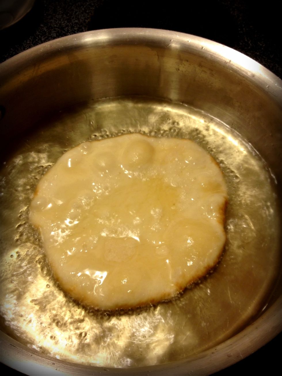 Heat about an inch of oil to 375 degrees. I didn't measure the temperature, I just warmed it to medium heat on my stove. Put the rolled dough in the oil. Let brown, flip, and brown on the other side.