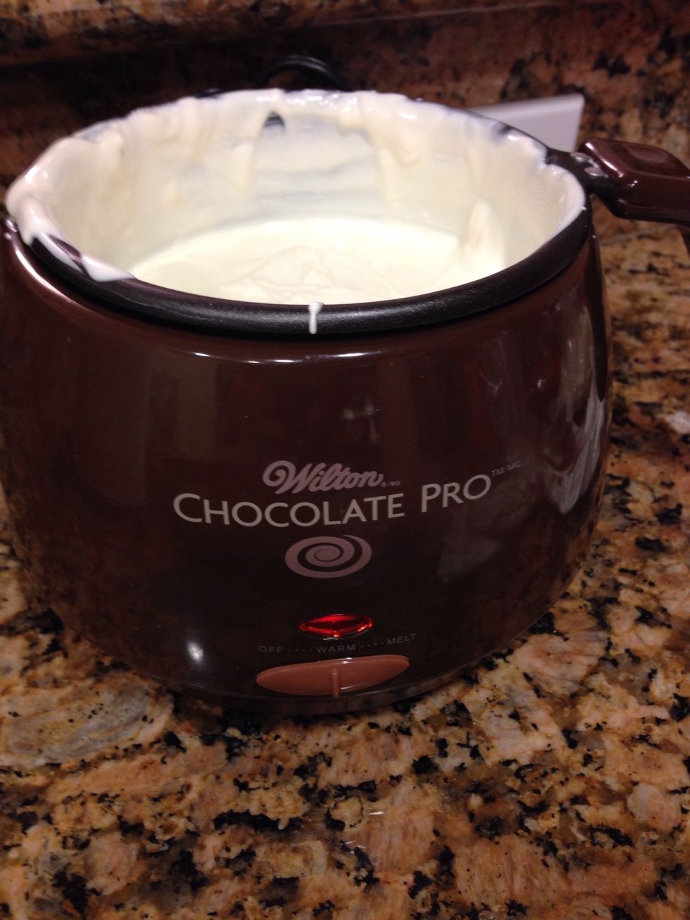 Heat and melt white chocolate. I've found that using a chocolate melting pot is easiest. Melting chocolate is finicky. Place a small amount (1 tablespoon) of melted chocolate on a flat surface.