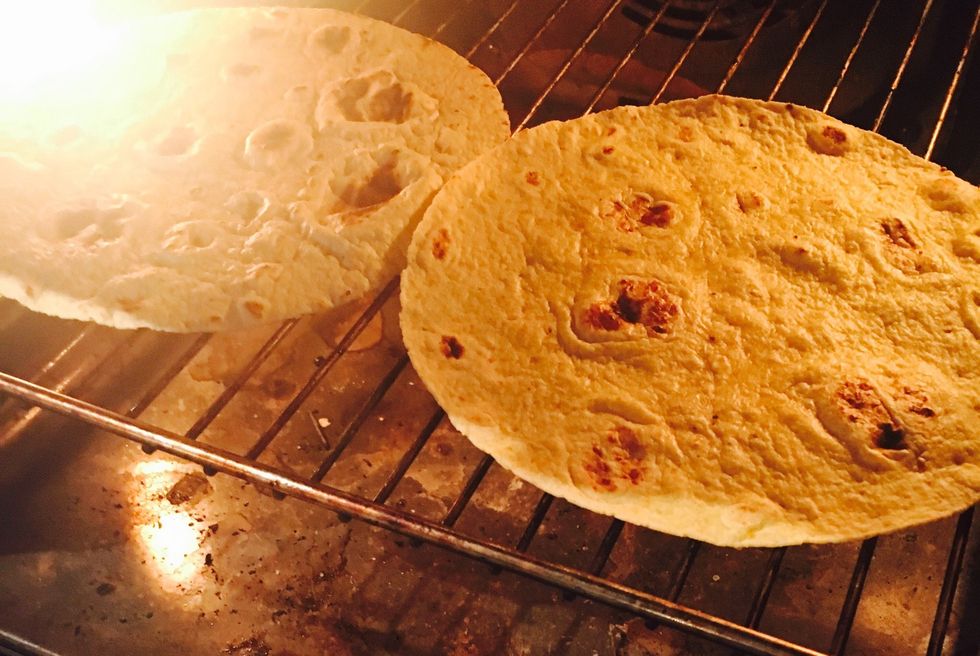 Heat corn tortillas on the broiler-function in your oven, directly on the rack(full heat). Keep an eye on it, it burns easily. Remove when golden and bubbles starts to appear.