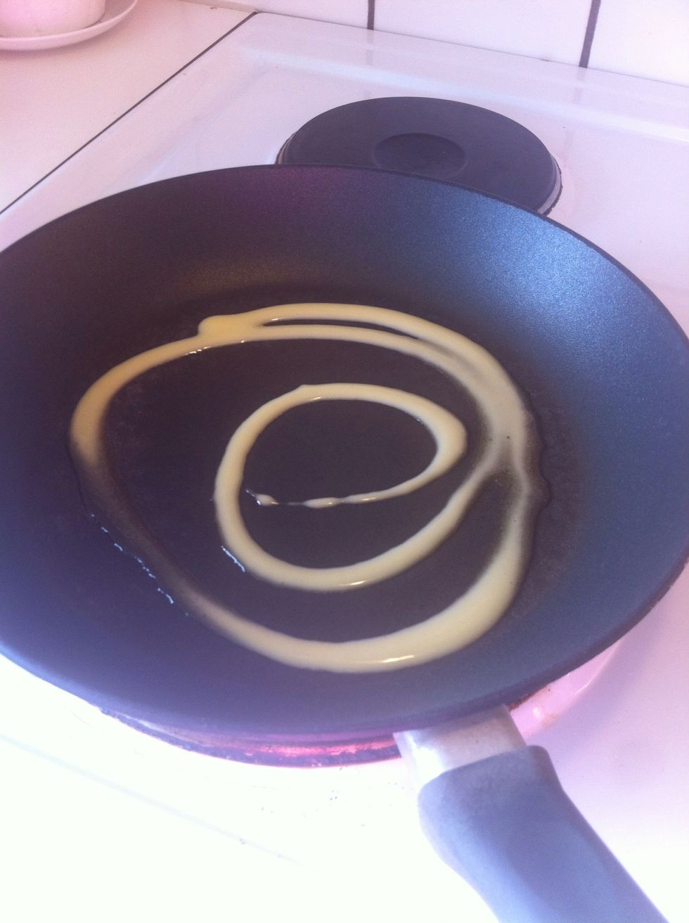 Heat frying pan to medium-high. Swirl some oil or liquid butter/margarine into pan.