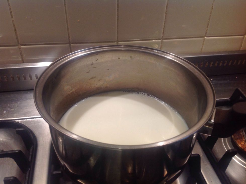 Heat milk in a saucepan until starting to foam and bubble. Then stir in vanilla bean paste.