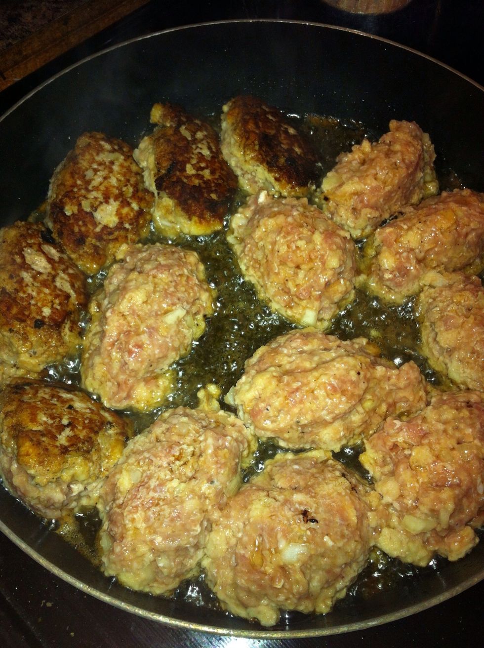 Heat oil and butter in a fry pan until bubbling. Scoop frikadeller using a large metal tablespoon. Fry on one side until browned, turn carefully with a fork.