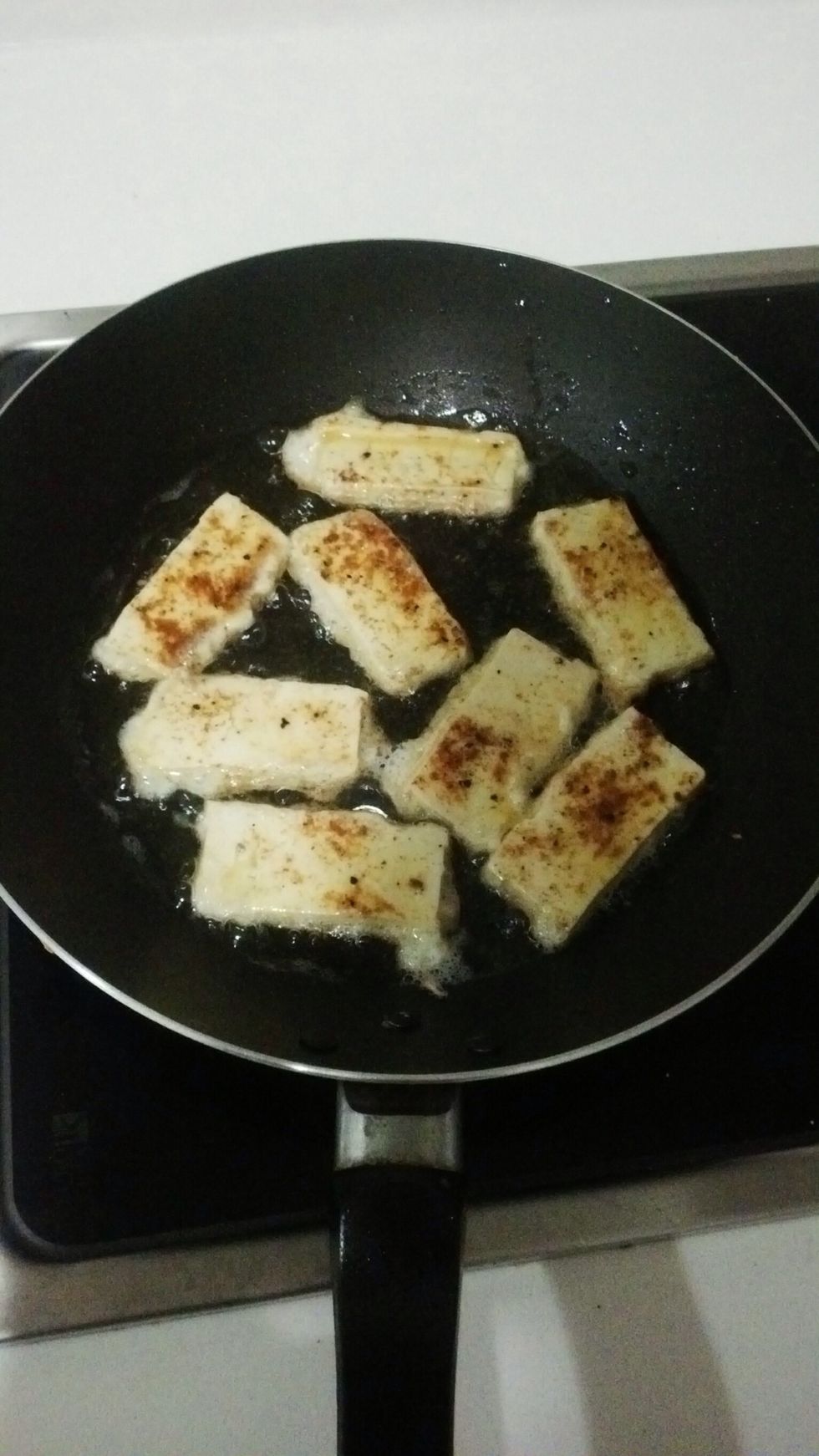 Heat oil, dip tofu strips in beaten whole egg and place in hot oil