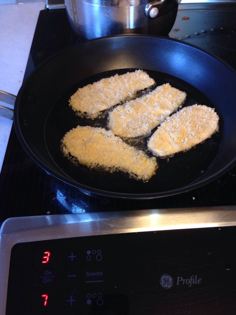 Heat oil in a pan, and place eggplants in the hot oil