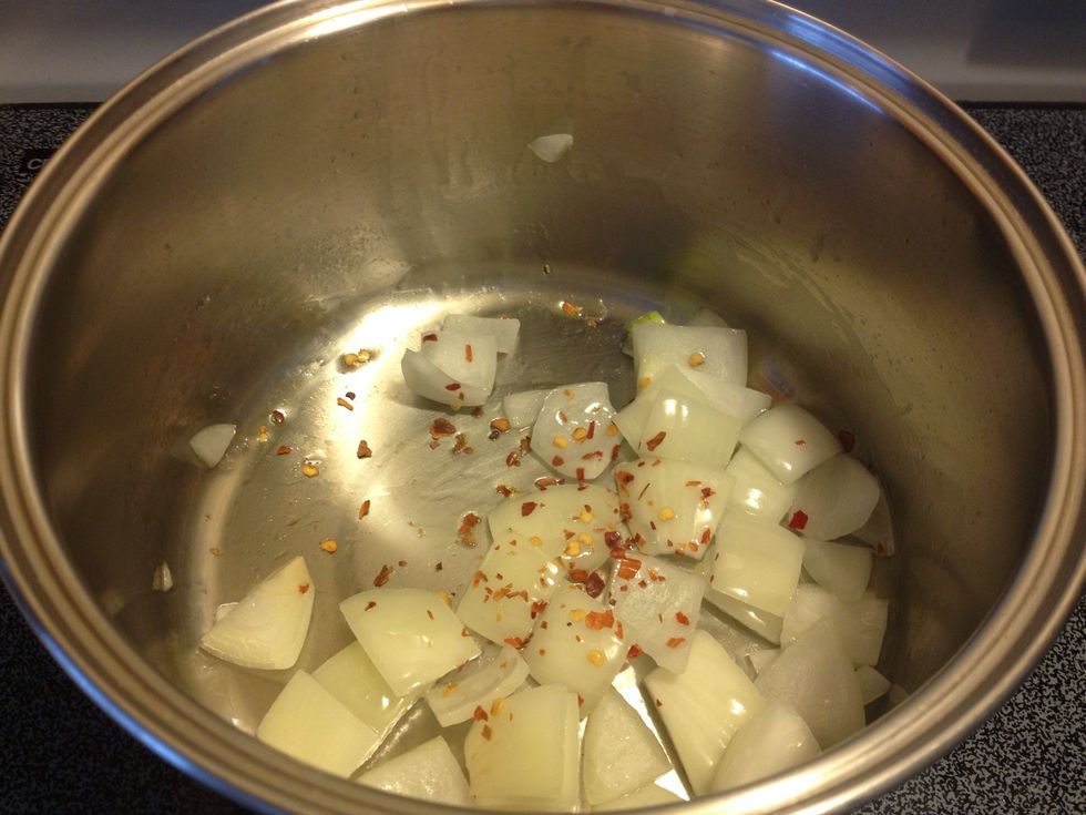 Heat oil in a pot and saut\u00e9 onions and chili flakes...