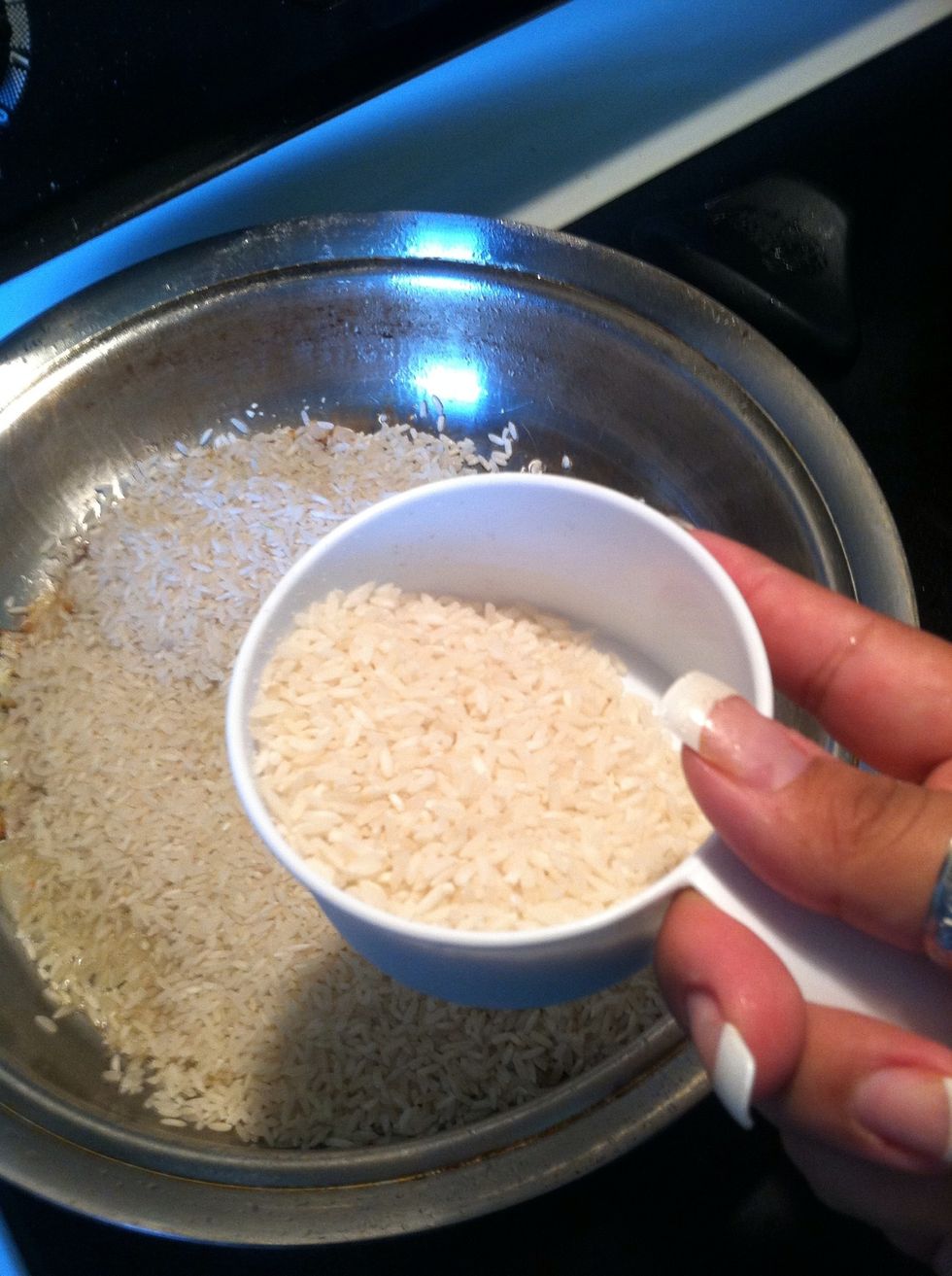 Heat oil in hot pan over medium head (Hint: #5 if on flat stove top). Add chopped onion and minced fresh garlic clove to hot oil, once starting to brown add rice.