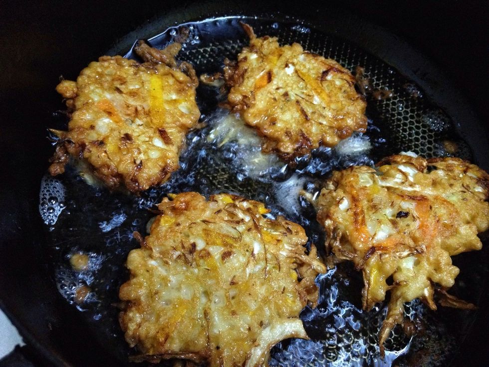 Heat oil in pan and drop spoonfuls of the battered ingredients. Fry both sides until golden brown. Drain excess oil on paper towel