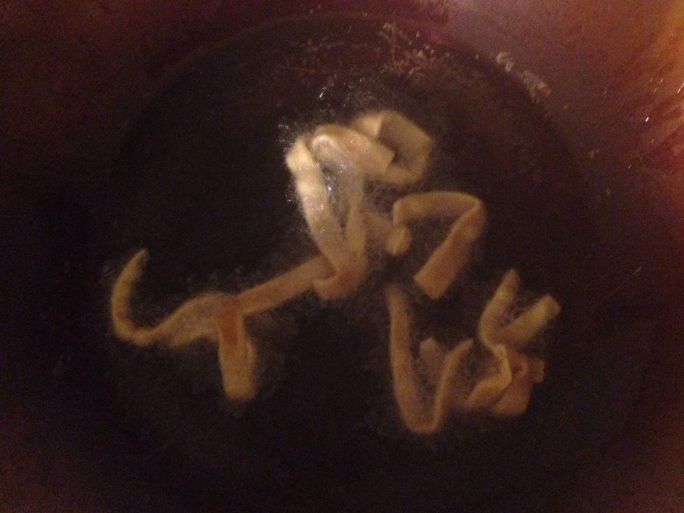 Heat oil (in wok) on stove at the high temperature setting. Fry the won ton in oil until golden brown (under a minute). Remove won ton from the oil with a metal strainer and place on a paper towel.