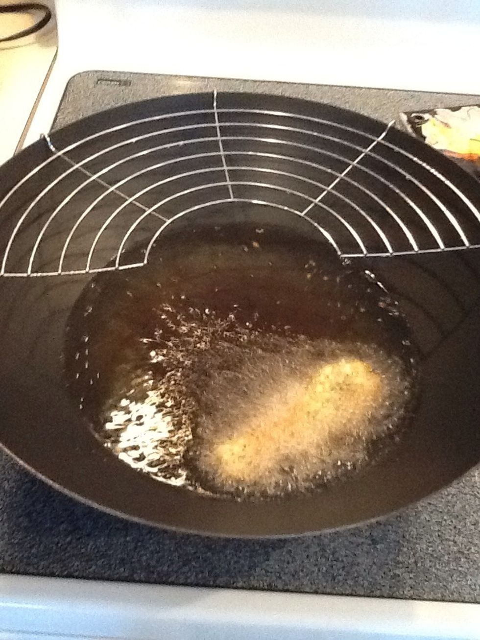 Heat oil in wok or deep fryer to medium low. Place pickle in hot oil. Flip after 8-10 seconds. Seriously. These babies brown quickly!