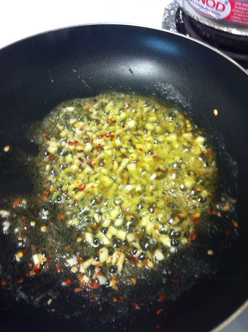 Heat olive oil and butter on medium heat and add garlic and red pepper flakes. Saut\u00e9 for 2 mins .