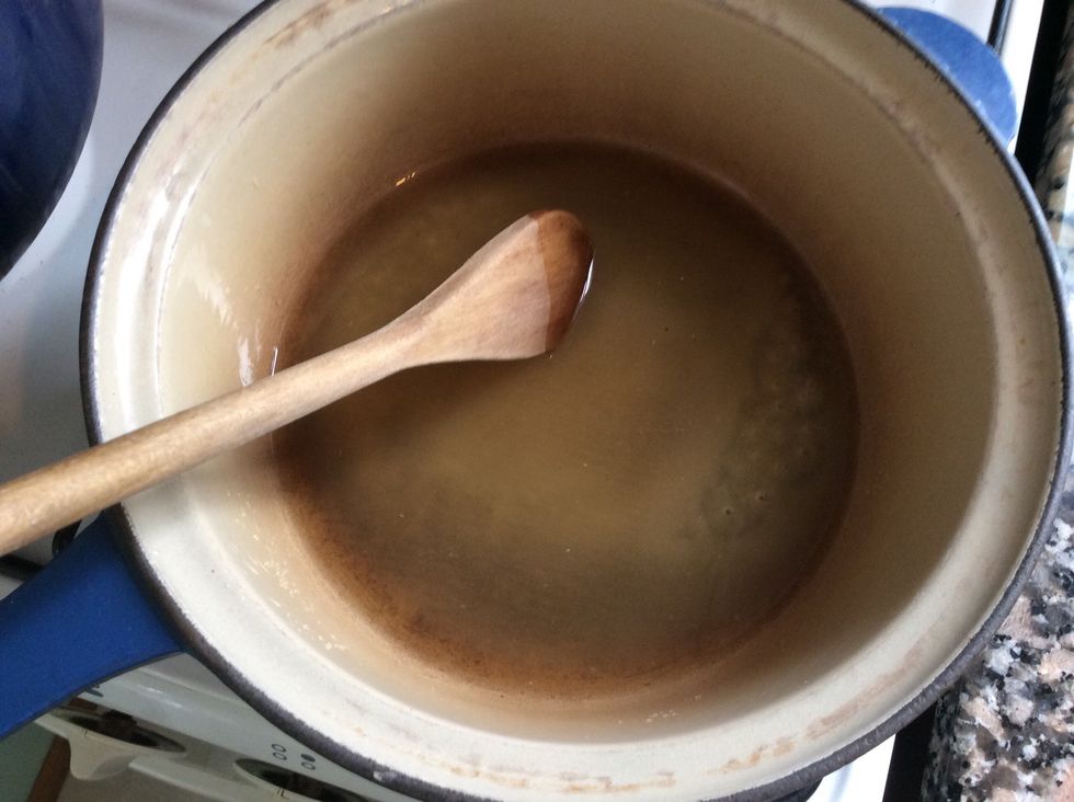 Heat over medium heat stirring constantly until sugar dissolves.  To check that it has all dissolved, examine a little of the liquid in a spoon, it should be clear with no little granules.