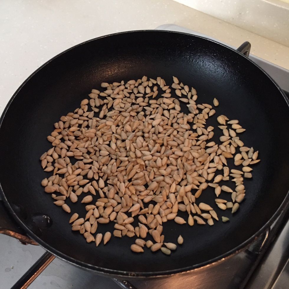Heat pan on medium heat, and pan roast the sunflower seeds until golden brown