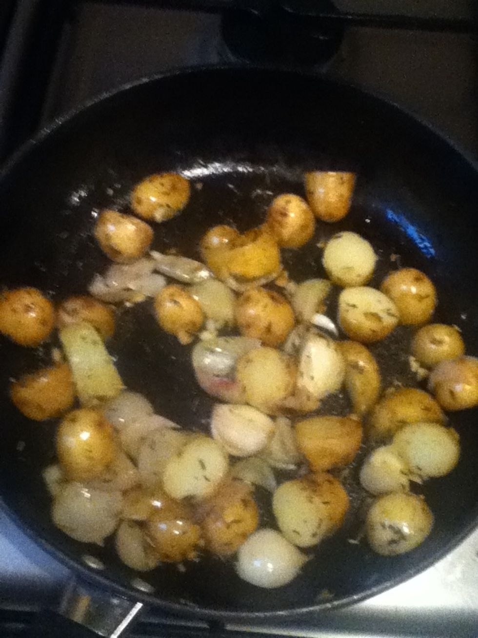 Heat remaining tblsp oil in skillet on medium heat with shallots + potatoes, stirring occasionally, until edges are browned, 3 to 5 mins. Stir in water + 1/2 remaining garlic mix + remove from heat.