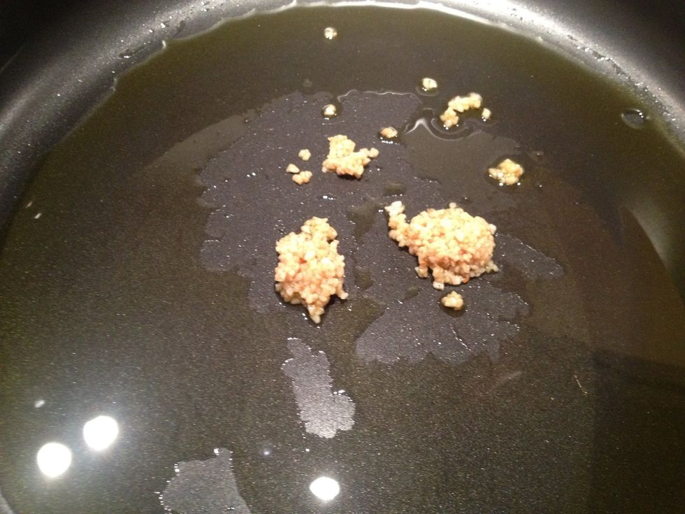 Heat skillet over medium high heat. Add two cloves of finely minced garlic. (I used the jarred kind) Saut\u00e9 about one minute. Don't burn!