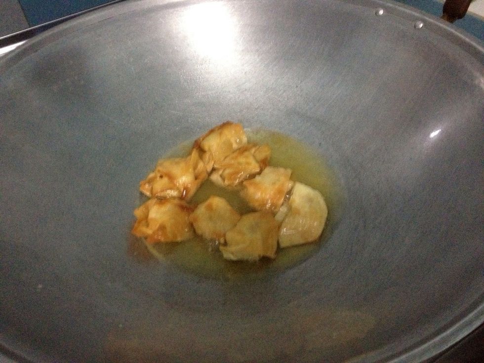 Heat some canola oil in a pan or wok. Fry some wontons and cook until golden brown. Set aside.