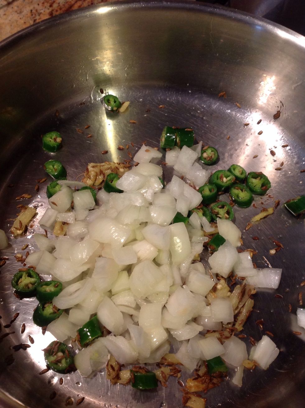 Heat some oil & add cumin seeds, fresh ginger, green chillies & the chopped onions