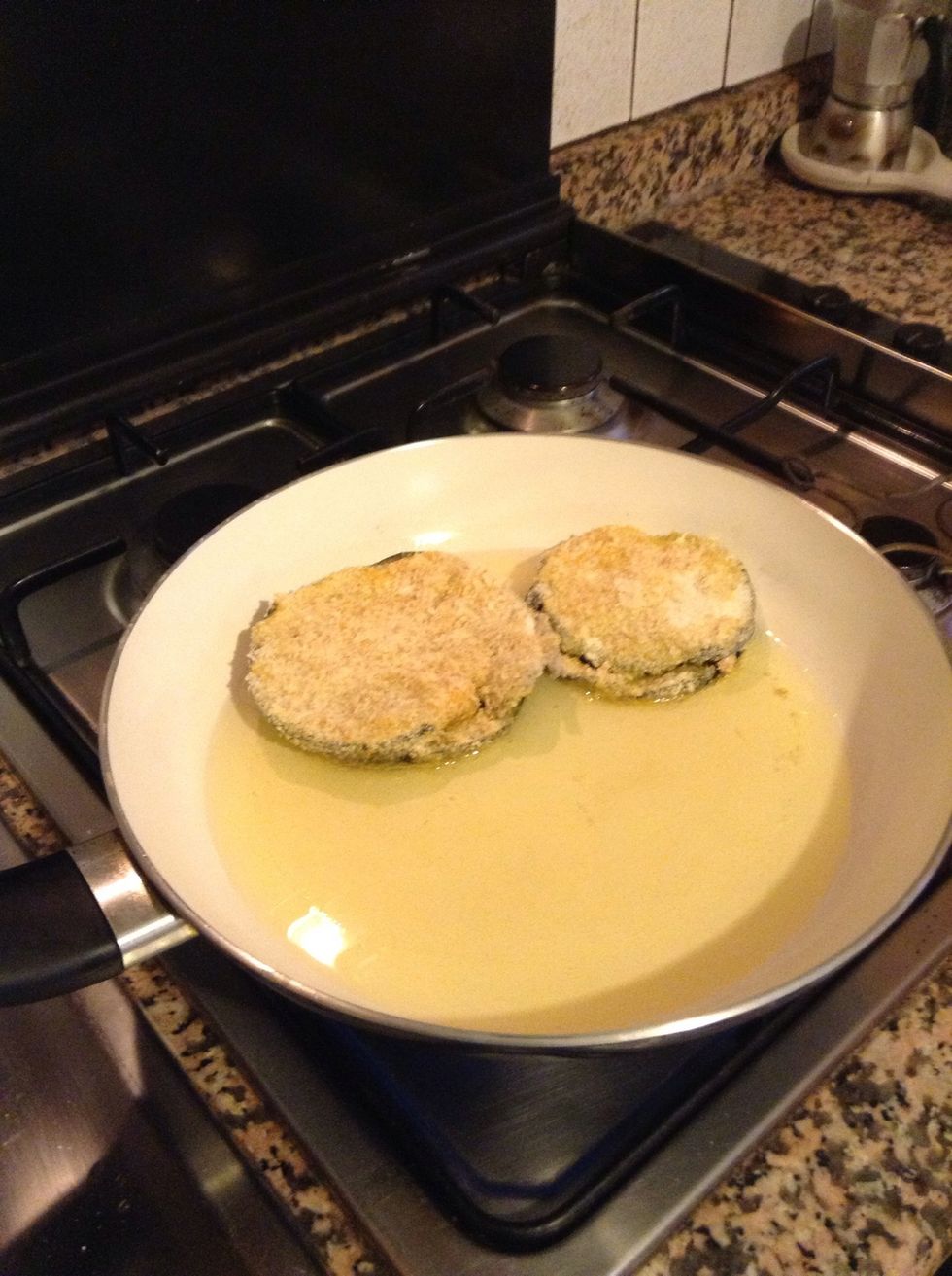 Heat some oil in a frying pan. Put your eggplants in the pan.
