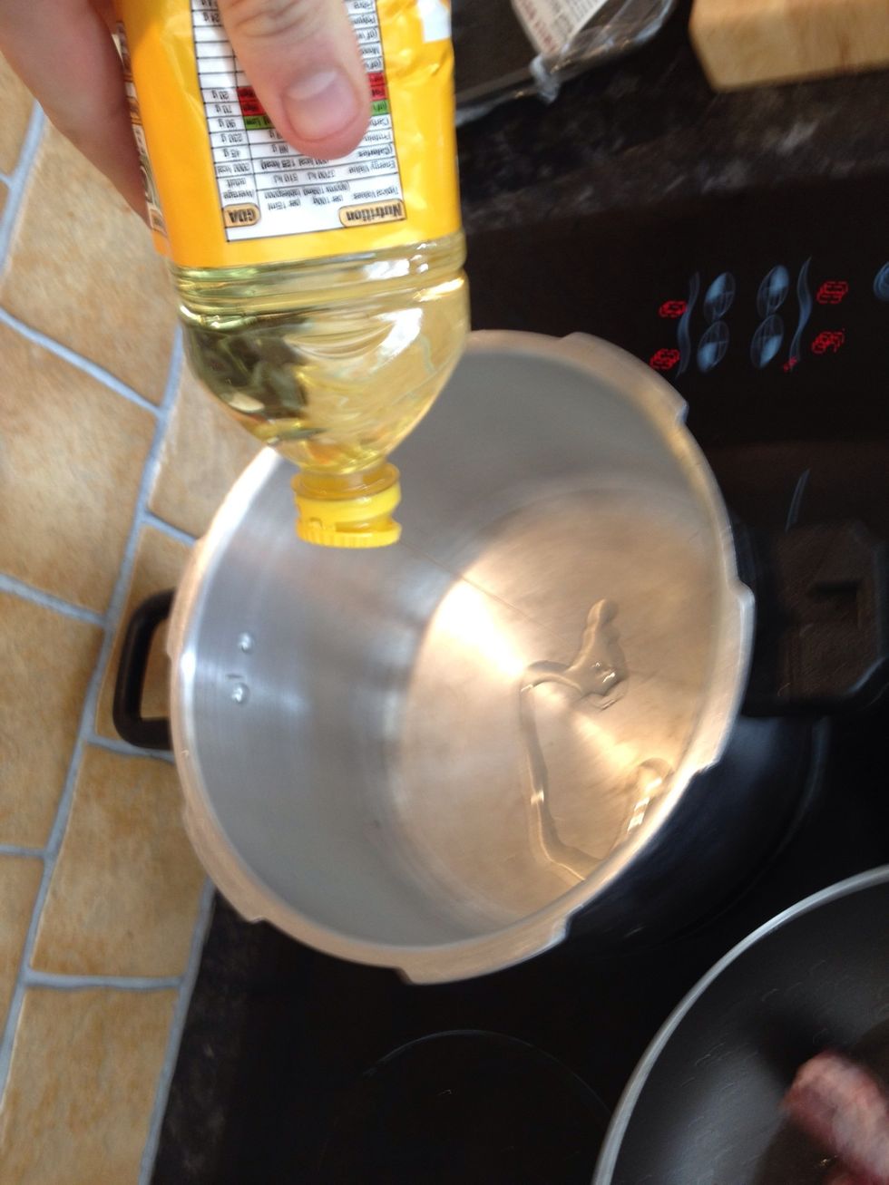 Heat sunflower oil in heavy pressure cooker pot