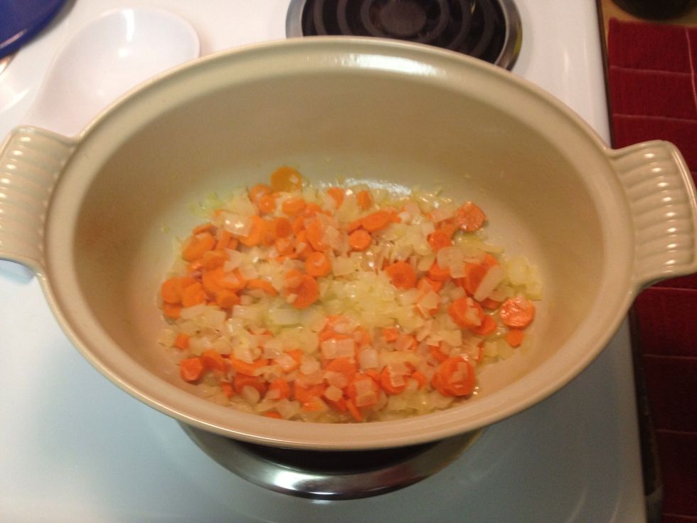 Heat the butter and a light coating of olive oil on medium heat (number 5). Then add minced garlic, chopped onion and sliced carrot. Cook for about 10 minutes