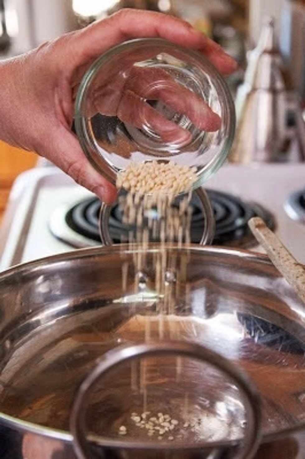 Heat the coconut oil in a skillet, kadhai or wok. When the oil is hot, toss in the urad dal.