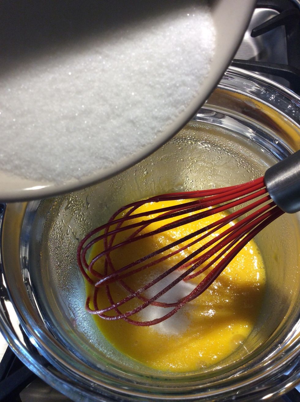 Heat the eggs slightly,  when the eggs are lightly warmed, gradually add the first 3/4 cup of sugar. Stirring constantly.