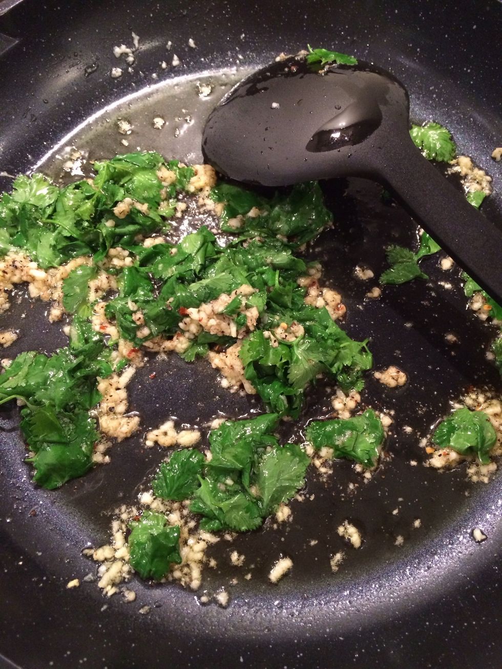 Heat the garlic until fragrant. Then add the coriander. Add pepper and chili stir