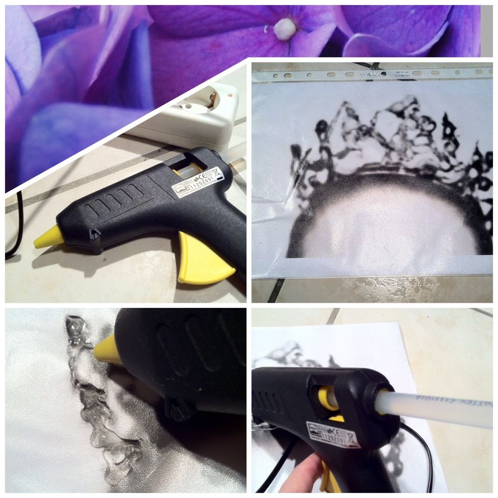 Heat the hot glue gun and print out a picture of the black swan crown. Put it in a plastic sleeve and once the hot glue gun is ready, start to trace it with the glue.