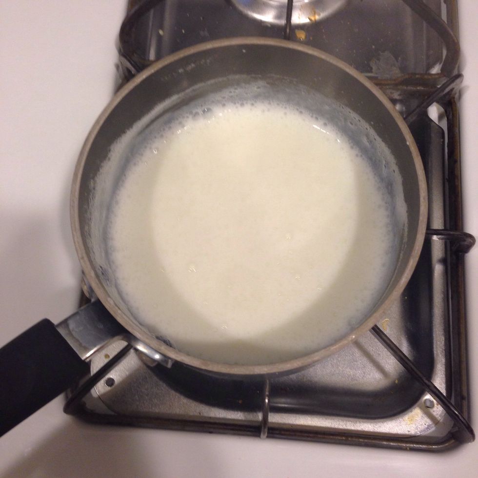 Heat the milk in a small saucepan until it bubbles, then remove from heat.